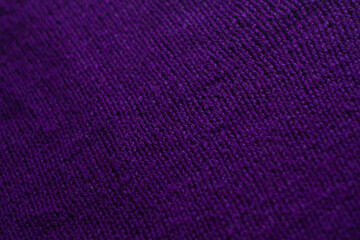 Fototapeta premium Knitted sweater with small braid, plain purple background.