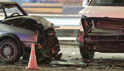 Cars crashed heavily in road accident after collision on city street at night. Road safety and...