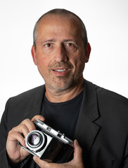 Middle-aged man holding a vintage camera