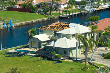 Hurricane Ian destroyed house roof in Florida residential area. Natural disaster and its consequences