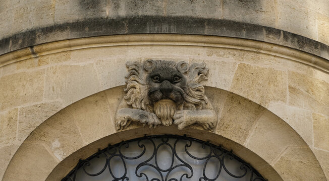 Bordeaux, France. At the historic district, a lion sculpture on the dintel of a shop entrance door.