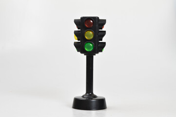 Black toy traffic light isolated on a white background