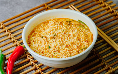 Korean instant spicy ramen dish in white bowl on table
