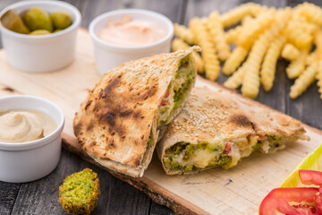 Falafel Pie wrap Meal with fries and dip served in dish isolated on table side view of arabic food