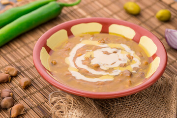 Foul with tahini served in dish isolated on table side view of arabic food