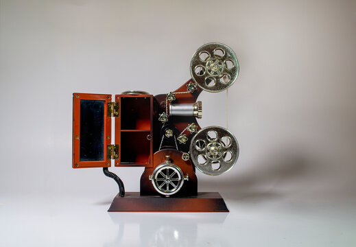 Jewelry in the form of a brown film camera on a white background