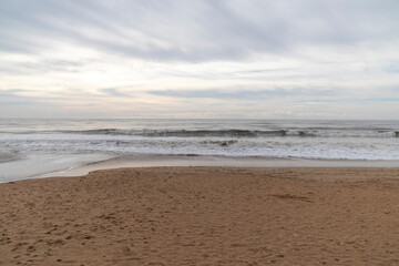 Frontal views of waves from the beach. A cloudy day.