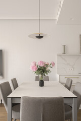 Warm white kitchen interior design, grey chairs, oak floor, rose peony in glass vase on dining table. Modern kitchen interior concept