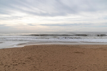 Frontal views of waves from the beach. A cloudy day.
