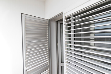 Obraz premium Door and window with regulating blinds, white.