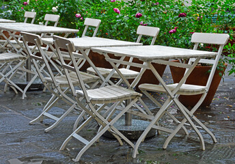 White chairs and tables of a street cafe