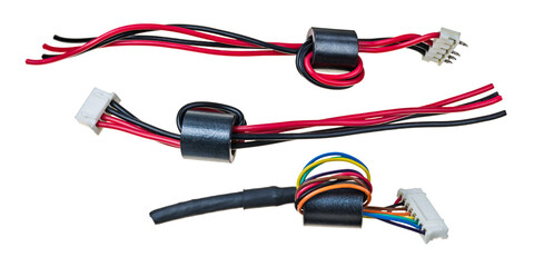 Ferrite bead inductors on insulated wires with plastic connectors isolated on a white background....