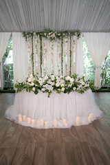 Wedding ceremony. Very beautiful and stylish roundwedding arch, decorated with various fresh flowers, standing in the garden.