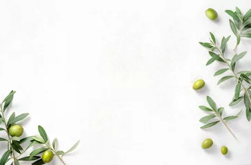 Fototapeten Olives and olive branches on white textured background. Background with olive leaves for your package and design. © Tatyana Sidyukova
