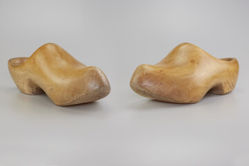 Two vintage wooden clogs in studio on white background