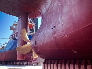 Ships propeller survey during dry docking of a vessel - obrazy, fototapety, plakaty