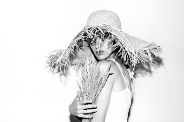 Portrait of young attarctive woman in straw hat	