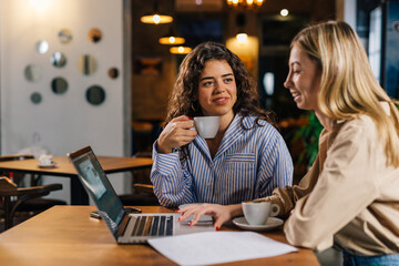 Owner of a small business talks to employee