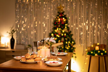 Table set with glass of champagne and christmas tree for celebration and toasting in holiday of new year