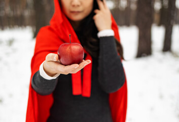 Red Hooded Woman Holding an Apple Fairytale Portrait - Fairytale image of a beautiful girl in a red...