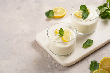 Creamy dairy yoghurt dessert sweet mousse with mascarpone, cream cheese, mint and lemon juice in...