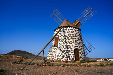 Disused windmill "Molino de Villaverde" in a central rural area of Fuerteventura island in the Canaries, Spain - Four-winged restored grinder in a dry volcanic area