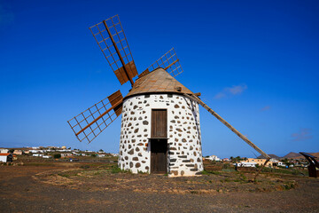 Disused windmill "Molino de Villaverde" in a central rural area of Fuerteventura island in the Canaries, Spain - Four-winged restored grinder in a dry volcanic area