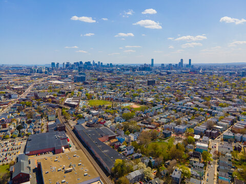Somerville city center aerial view on Somerville Avenue with Boston skyline at the background in spring, city of Somerville, Massachusetts MA, USA. 