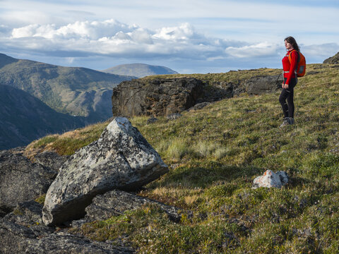 A woman exploring the mountains and wilderness of the Yukon. Feeling alive and vibrant in the beautiful scenery around Haines Junction; Yukon, Canada