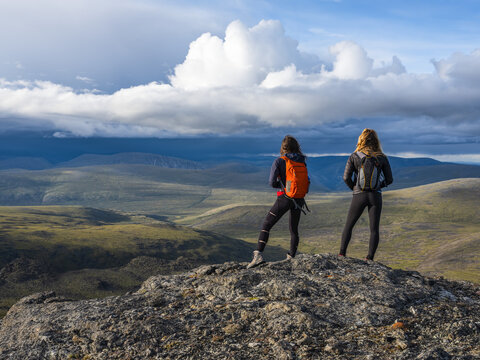 Two women exploring the mountains and wilderness of the Yukon. Feeling alive and vibrant in the beautiful scenery around Haines Junction; Yukon, Canada