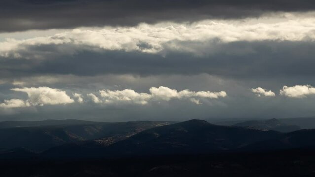 Illuminated Clouds in Dark Storm over Landscape Timelapse
