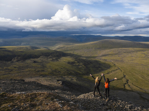 Two women exploring the mountains and wilderness of the Yukon. Feeling alive and vibrant in the beautiful scenery around Haines Junction; Yukon, Canada