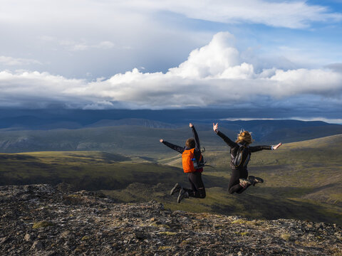 Two women exploring the mountains and wilderness of the Yukon. Feeling alive and vibrant in the beautiful scenery around Haines Junction; Yukon, Canada