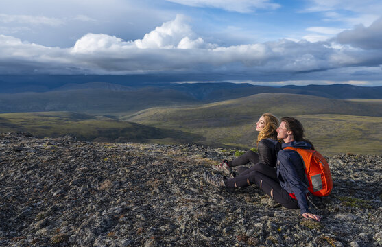 Two women exploring the mountains and wilderness of the Yukon. Feeling alive and vibrant in the beautiful scenery around Haines Junction; Yukon, Canada