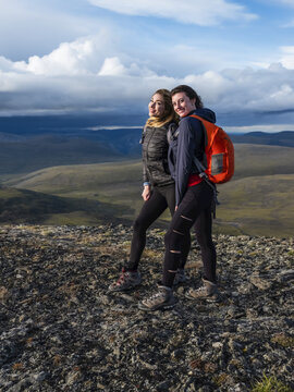 Two women exploring the mountains and wilderness of the Yukon. Feeling alive and vibrant in the beautiful scenery around Haines Junction; Yukon, Canada