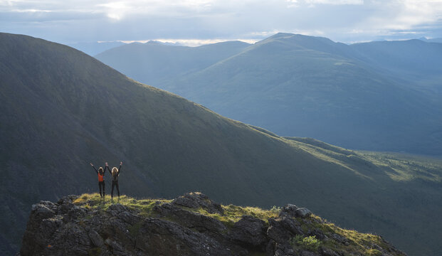 Two women exploring the mountains and wilderness of the Yukon. Feeling alive and vibrant in the beautiful scenery around Haines Junction; Yukon, Canada
