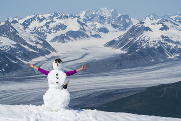 Snowman with arms and champagne bottle on a mountain top in Kluane National Park and Reserve; Haines Junction, Yukon, Canada