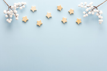 Natural wooden stars and rowan branches on a blue background, Christmas background, Merry Christmas and Happy New Year concept, top view, copy space