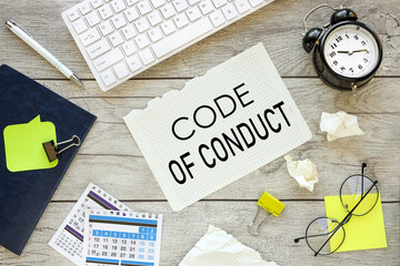 Code of conduct symbol. work desk top view calendar yellow stickers Copy space.