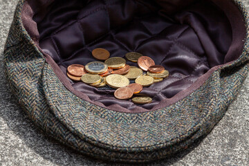 Euro coins in a cap