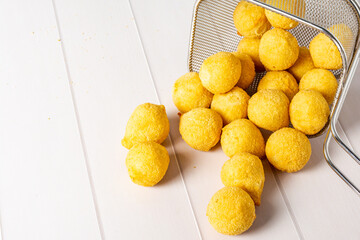 'salgadinho de festa' or brazilian traditional party snack. a mix made of coxinha, bolinha de queijo and risolis..on a frying basket
