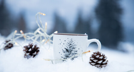 Fototapeta na wymiar mug with hot drink in snow for Christmas