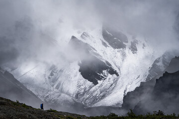 Lone hiker trekking in front of a huge and amazing landscape in Kluane National Park, Yukon.