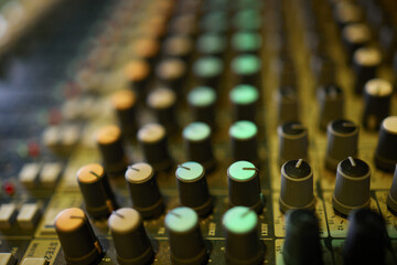 View of music mixer in concert, filled with lights.