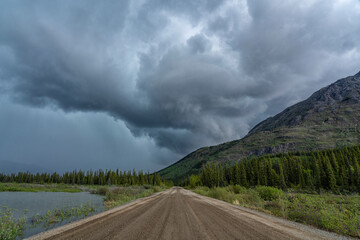 A storm creates drama in the Yukon skies during a warm summer day. Heavy rain and hail can be seen; Whitehorse, Yukon, Canada