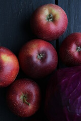 Red juicy apples on an old vintage table.