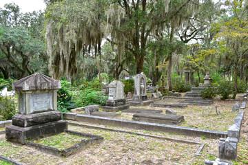 A row of old and worn tombstones in Bonaventure Cemetery in Savannah, Georgia.