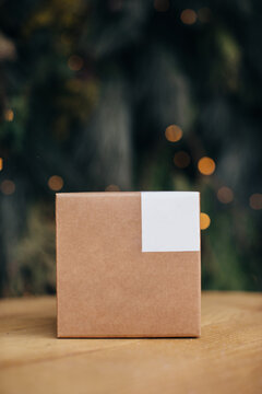 Mockup. Kraft paper boxes with white stickers on Christmas background.
