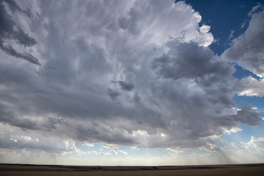 Storm clouds gather over expansive landscape; North Dakota, United States of America