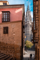 Old town alley and cathedral tower of Toledo